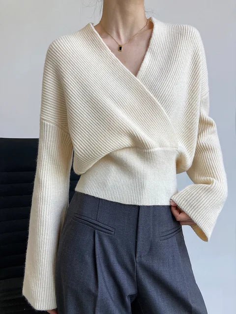 Knitted sweater with crossed V-neck and wrap pattern